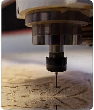 Close-up of a CNC router bit carving detailed patterns into a wooden surface, highlighting precision woodworking tools.