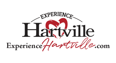Black and red stylized logo featuring the word Hartville with a heart shape integrated above the letter V and cursive text underneath, representing a home improvement brand.