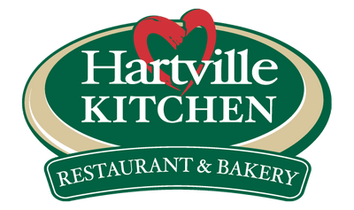 Oval green logo with a red heart shape above the word Hartville and bold white text reading Kitchen and Restaurant & Bakery below it